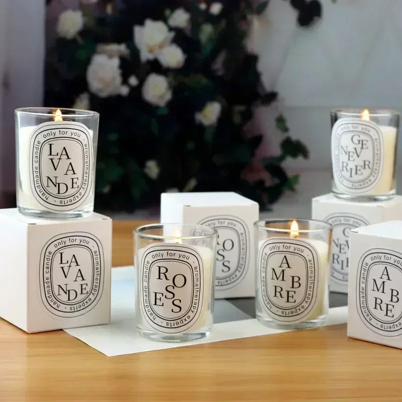 Candles with labels on a wooden surface with a blurred floral background